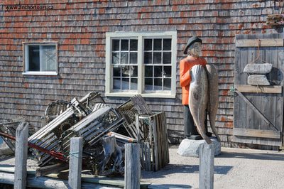 Halifax day trip to Peggy's Cove, Nova Scotia. Lobster traps and wooden statue