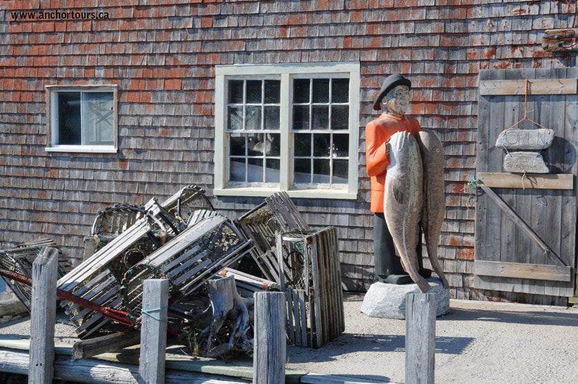 Lobster traps and wooden fishermen at Peggys Cove are popular items among tourists at Peggys Cove.
